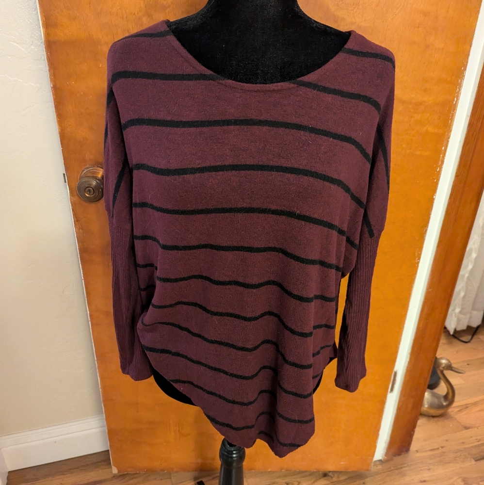 Asymmetric sweater with peekaboo detailing in back